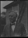 Image of Man wearing bow tie, by frame building